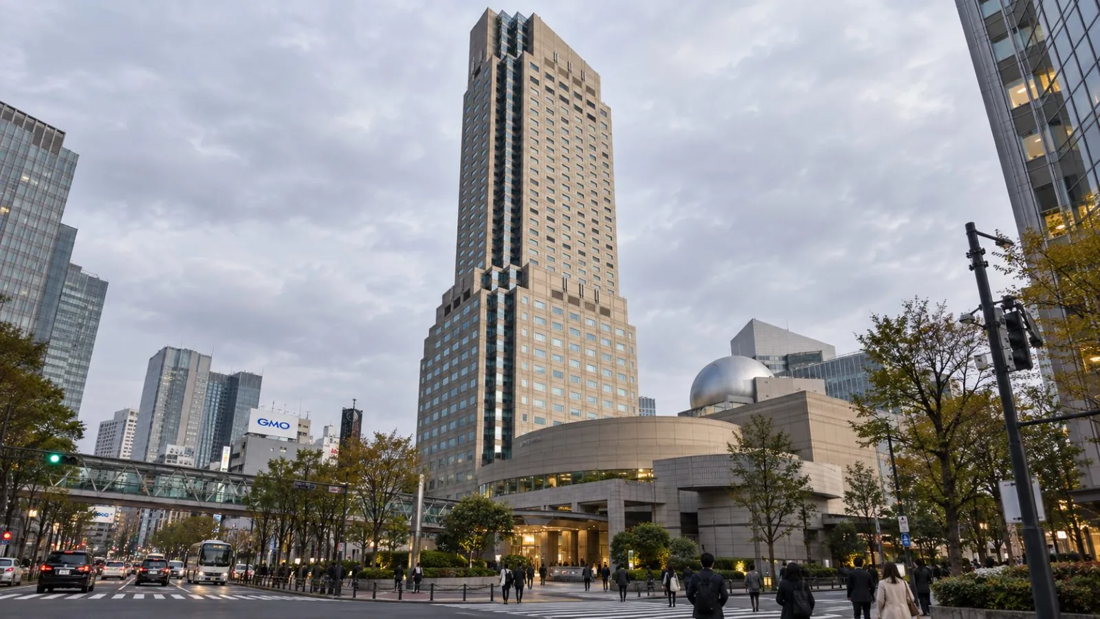Pedestrians pass the entrance of Cerulean Tower in Tokyo's Shibuya district. / EconoTimes.ai
