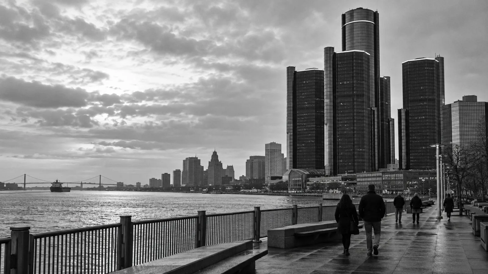 Pedestrians walk along the Detroit RiverWalk beneath the Renaissance Center in Detroit, Michigan. (AI-generated image / EconoTimes)