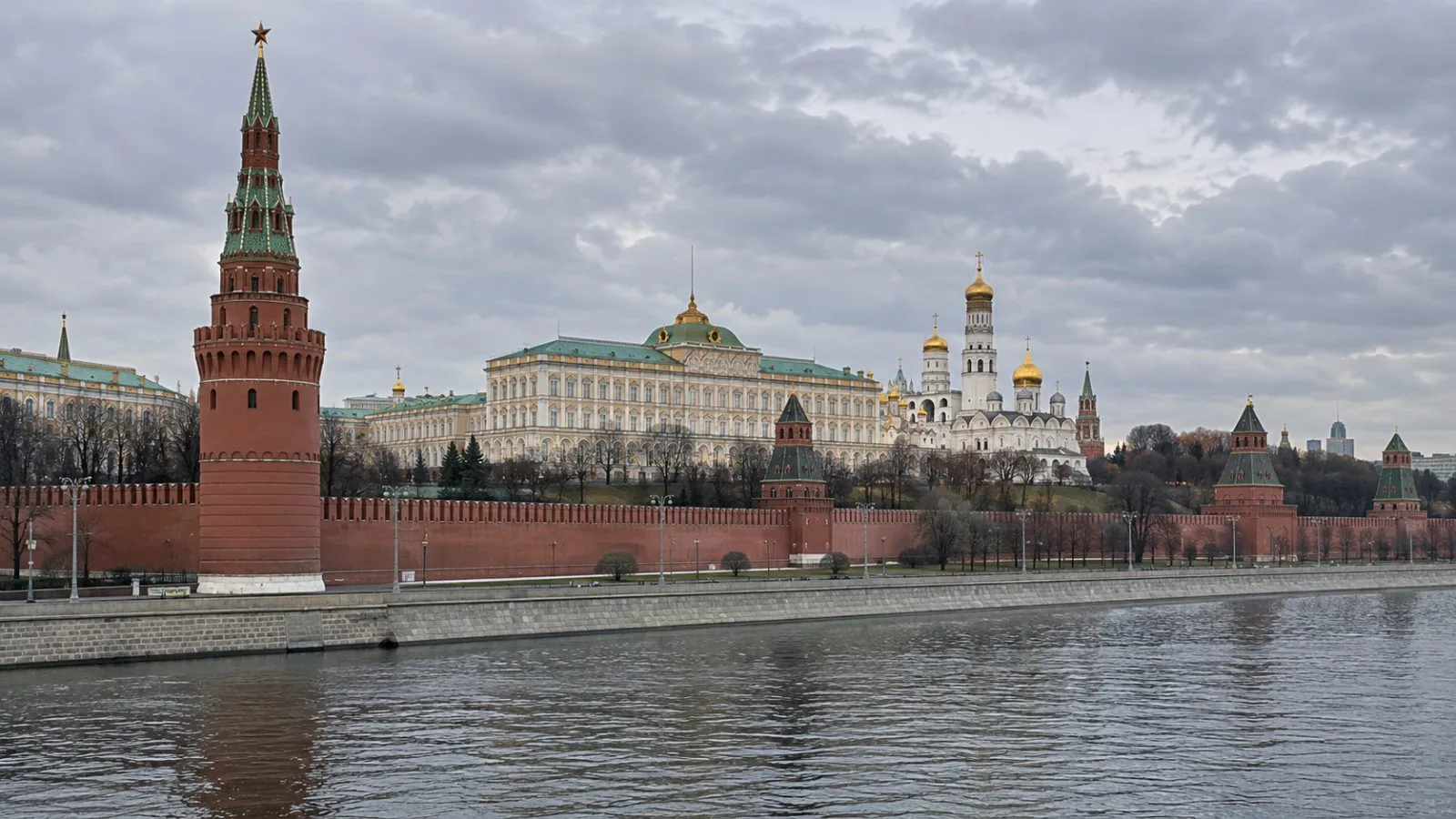The Kremlin walls and towers rise above the Moscow River in central Moscow (AI-generated image / EconoTimes)