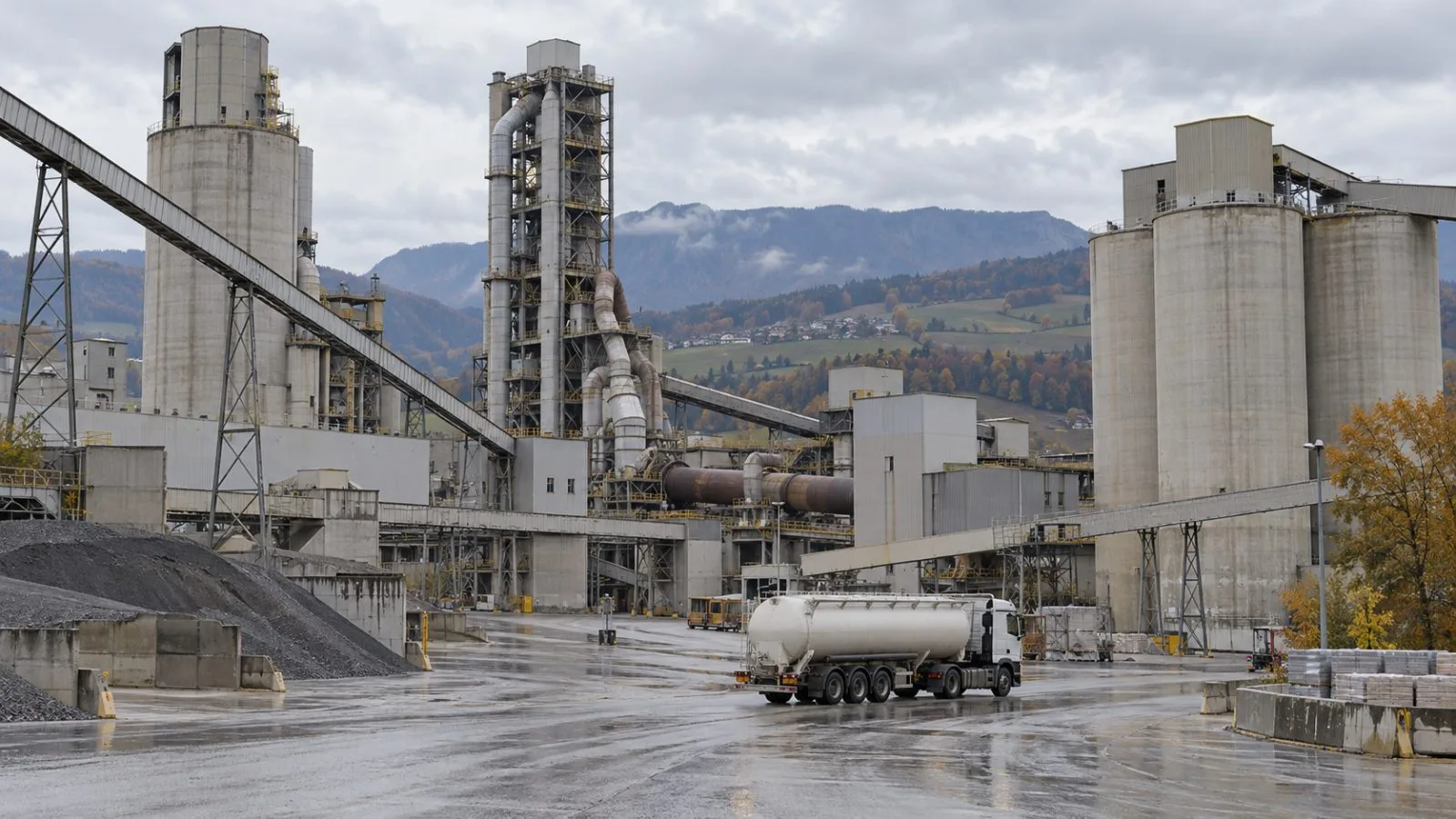 Cement silos and a kiln stand at the Eclépens works in western Switzerland (AI-generated image / EconoTimes)
