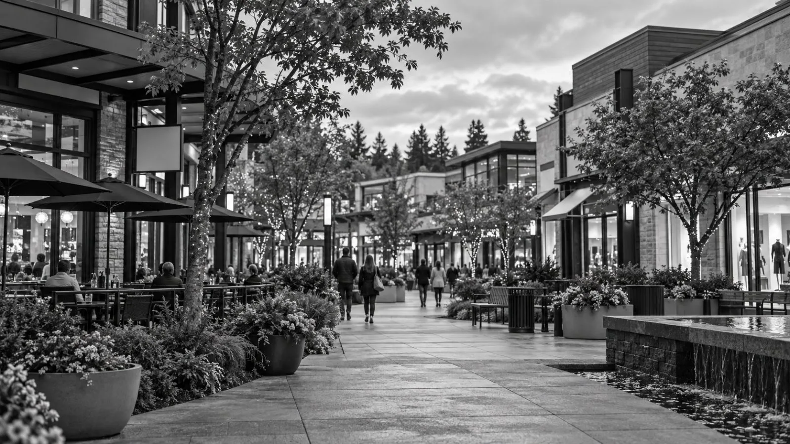 Shoppers walk past storefronts at University Village, an open-air retail center in Seattle, Washington / EconoTimes.ai