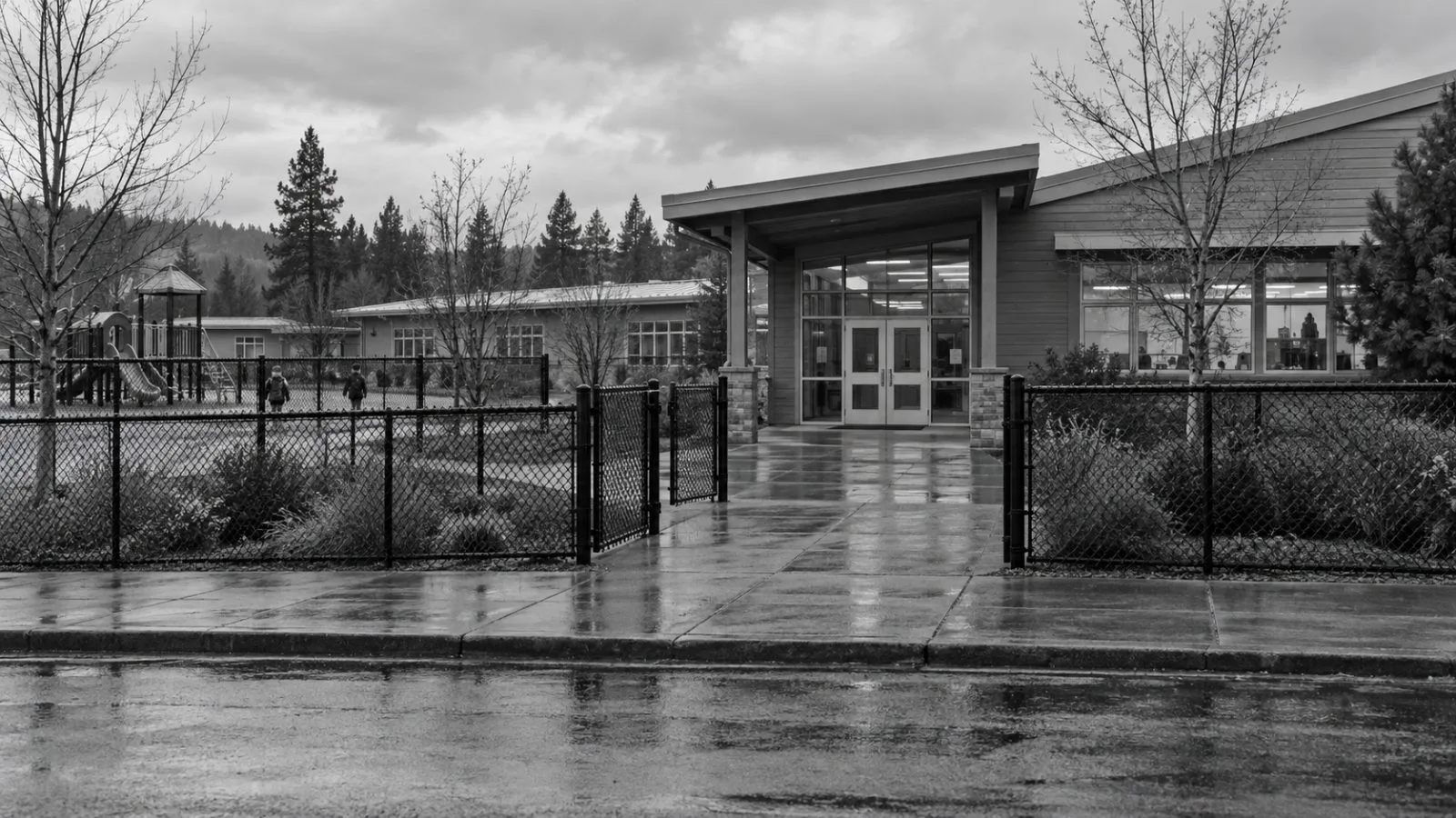 Exterior doors and a perimeter fence stand at Silver Rail Elementary School in Bend, Oregon. (AI-generated image / EconoTimes)