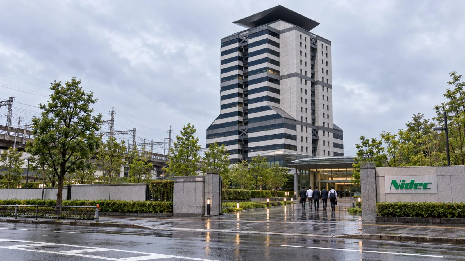 An office entrance faces a rain-darkened access road in Kyoto, Japan. / EconoTimes.ai