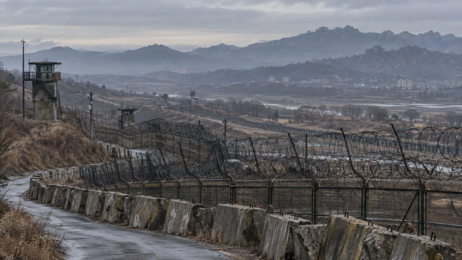 Concrete fortifications and fencing line the inter-Korean border near Kaesong, North Korea (AI-generated image / EconoTimes)