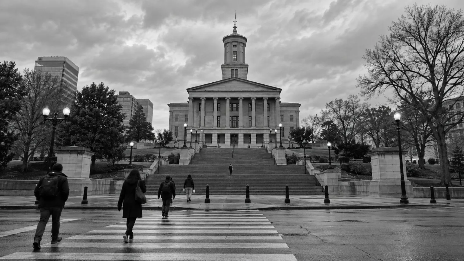 Pedestrians pass the Tennessee State Capitol in Nashville under an overcast sky. (AI-generated image / EconoTimes)