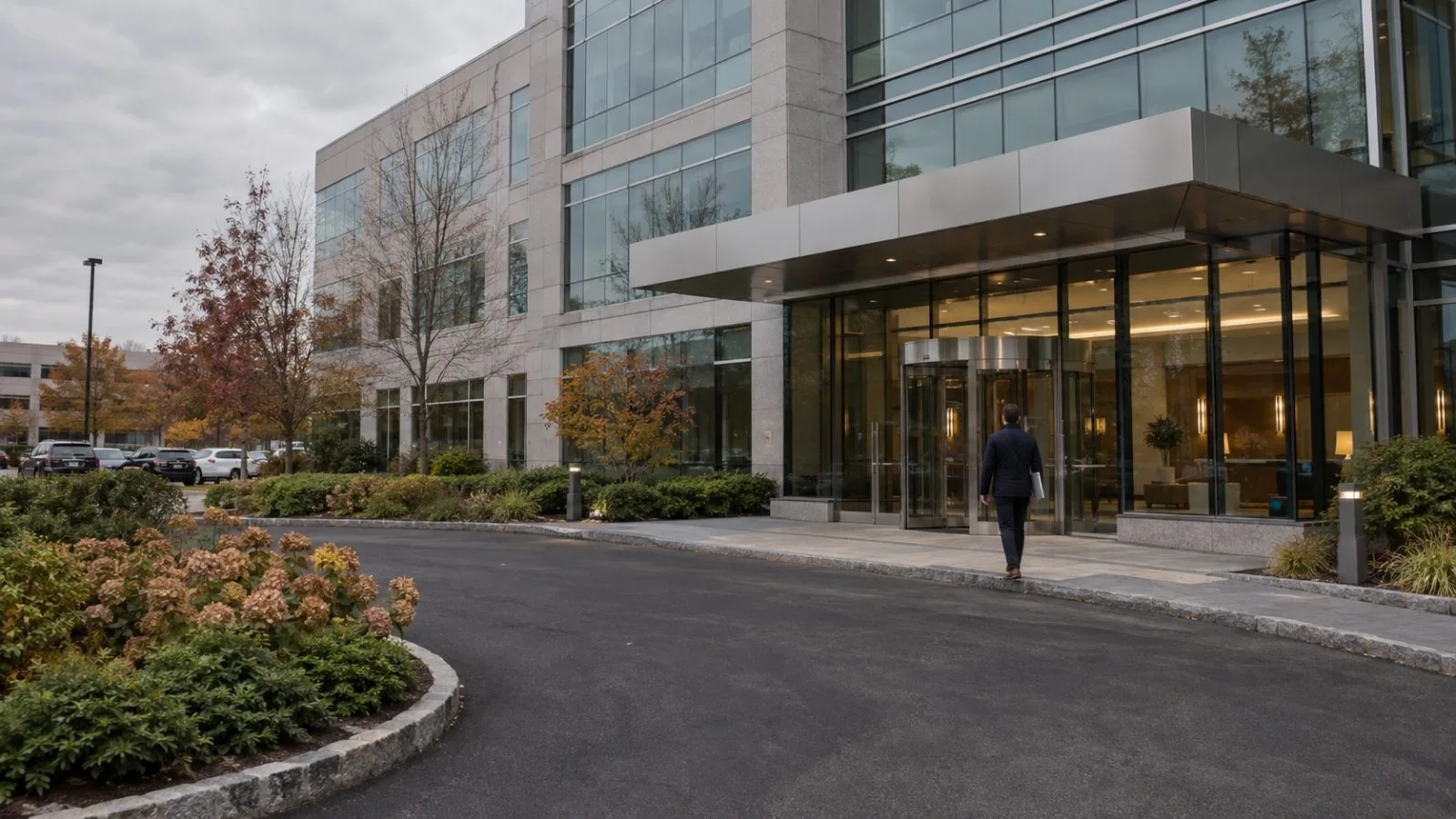 An employee enters J.S. Held’s headquarters on Jericho Quadrangle in Jericho, New York. (AI-generated image / EconoTimes)