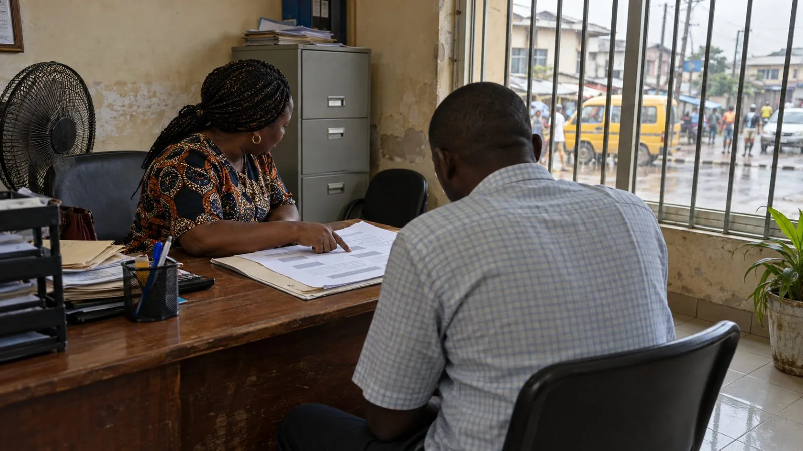 An insurance agent discusses a policy with a customer at a Lagos office in Nigeria (AI-generated image / EconoTimes)