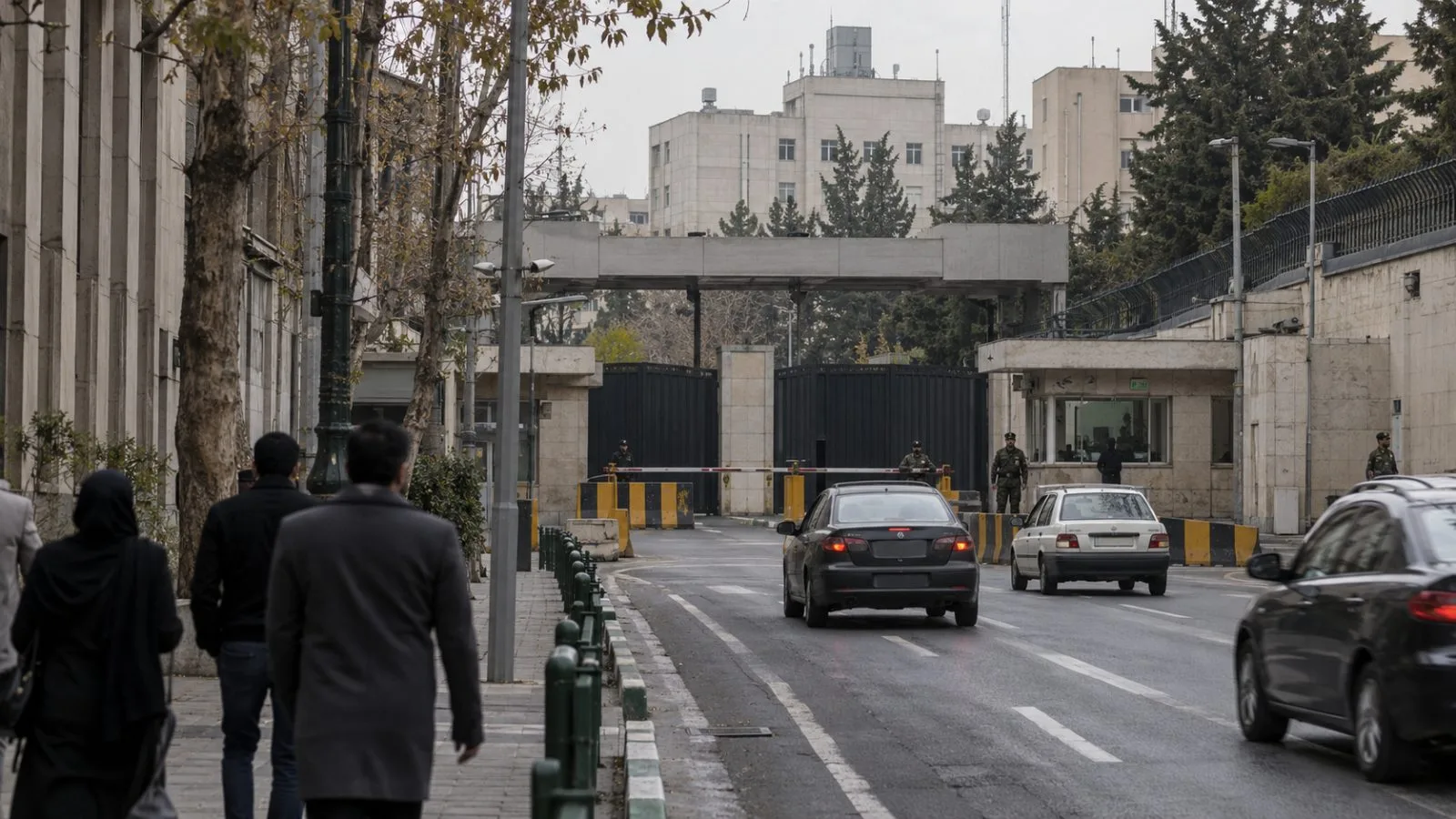 Pedestrians pass a guarded government compound in Tehran, Iran, under an overcast afternoon sky (AI-generated image / EconoTimes)