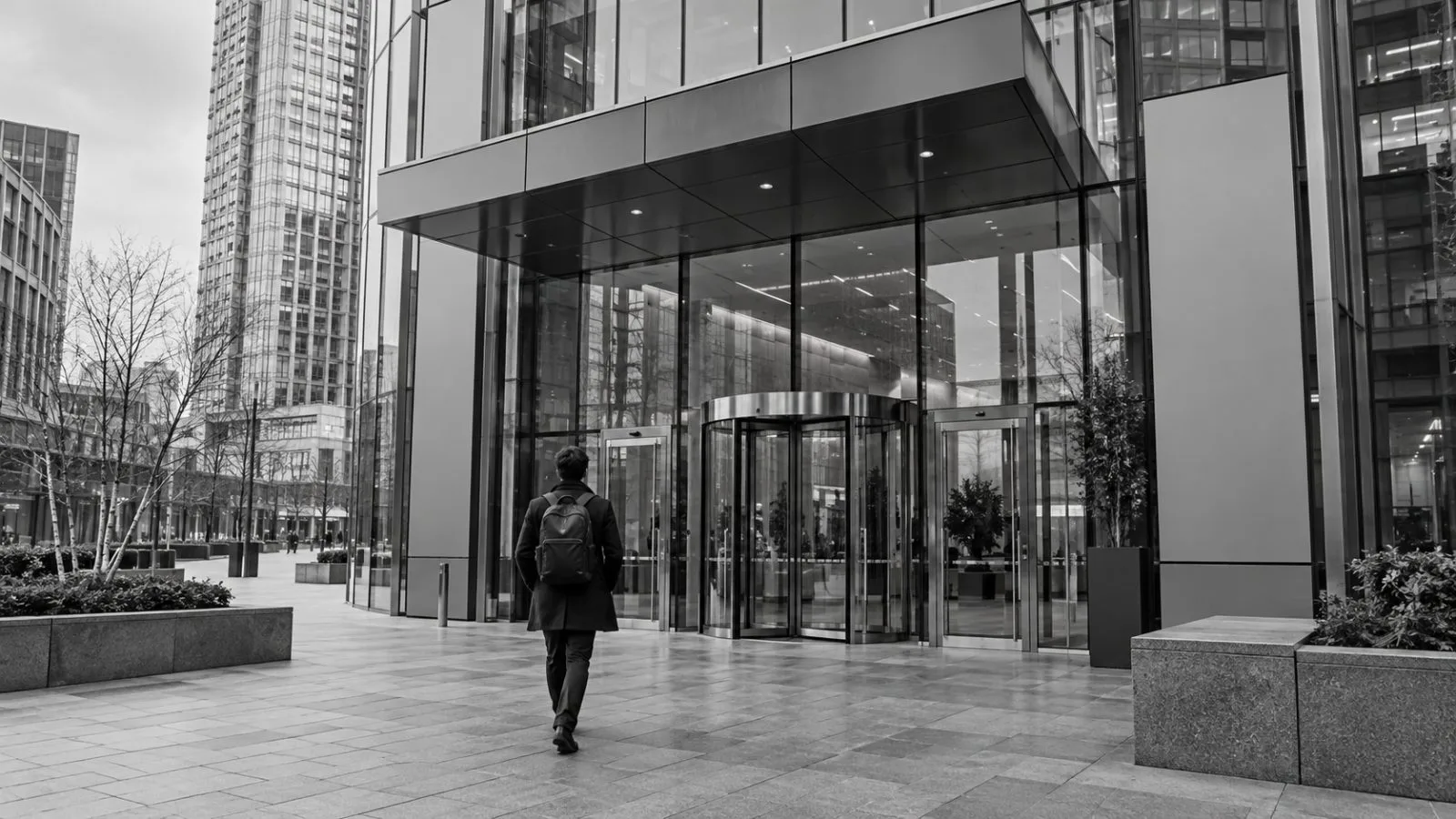 A passerby checks a phone outside the Financial Conduct Authority headquarters in London. / TokenPost.ai (mono)