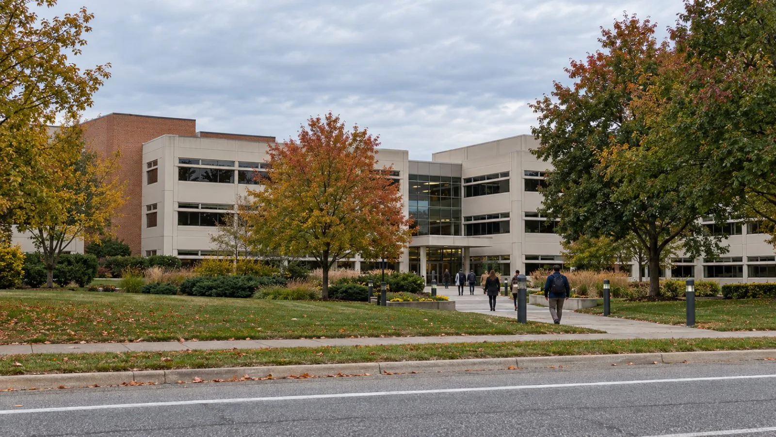 People walk toward a headquarters building in Benton Harbor, Michigan, on an overcast morning. / EconoTimes.ai