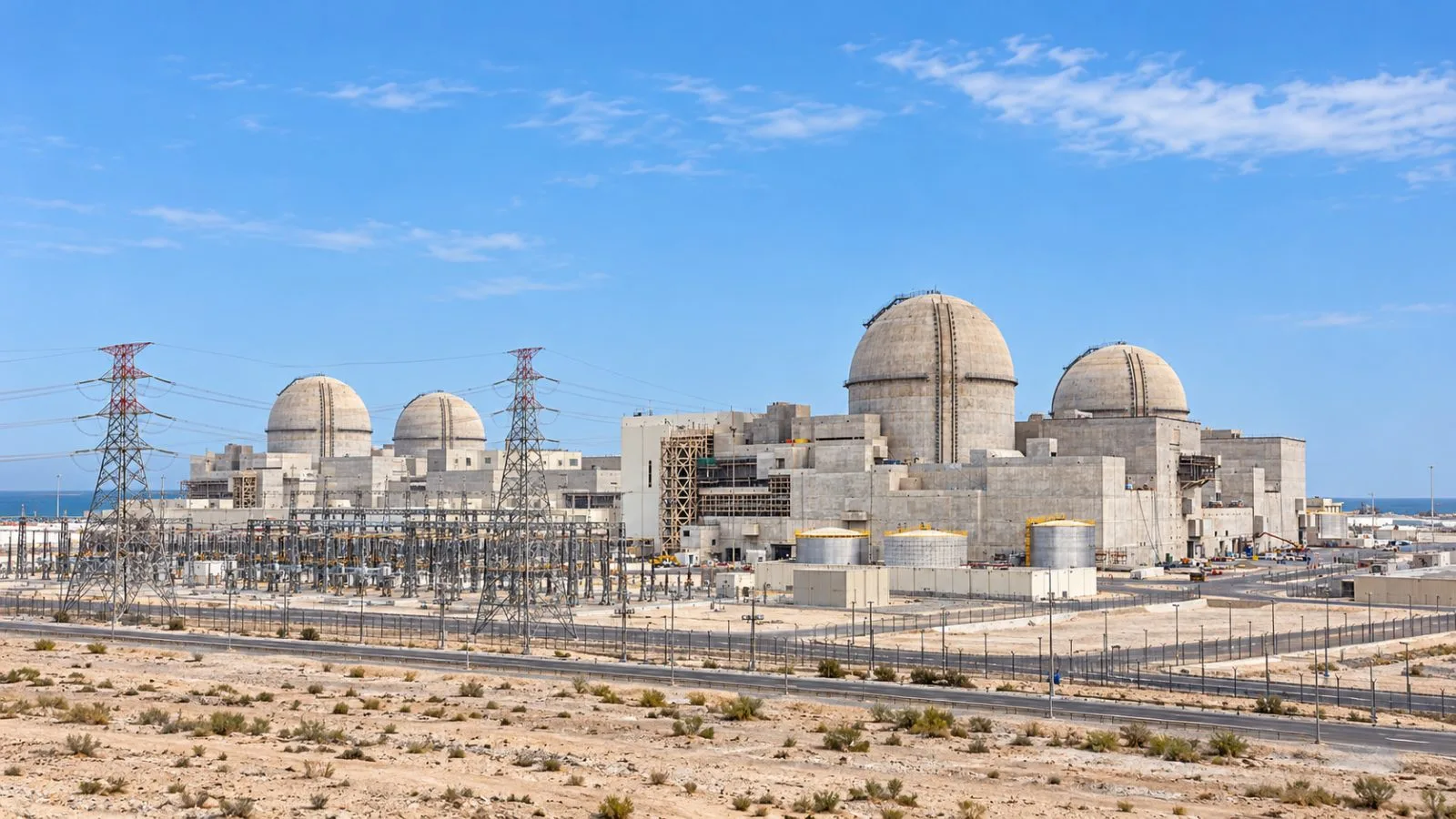 Power lines stand beside the Barakah Nuclear Power Plant near Ruwais, UAE. / EconoTimes.ai