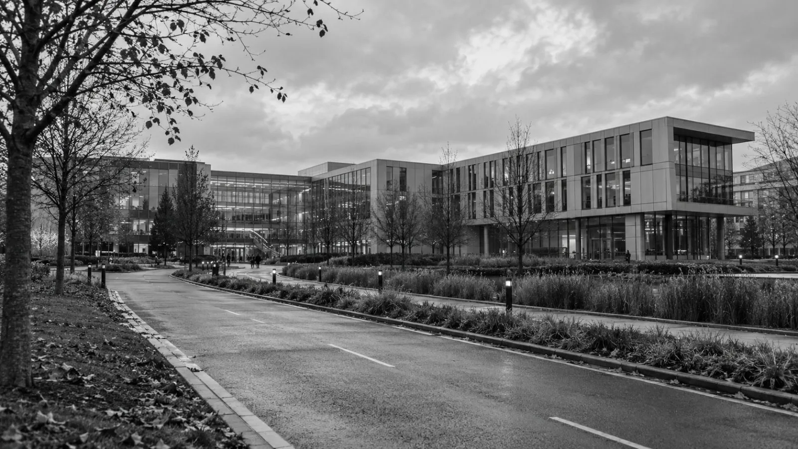 Campus buildings line an access road at Cambridge Innovation Campus in Cambridge, England. (AI-generated image / EconoTimes)