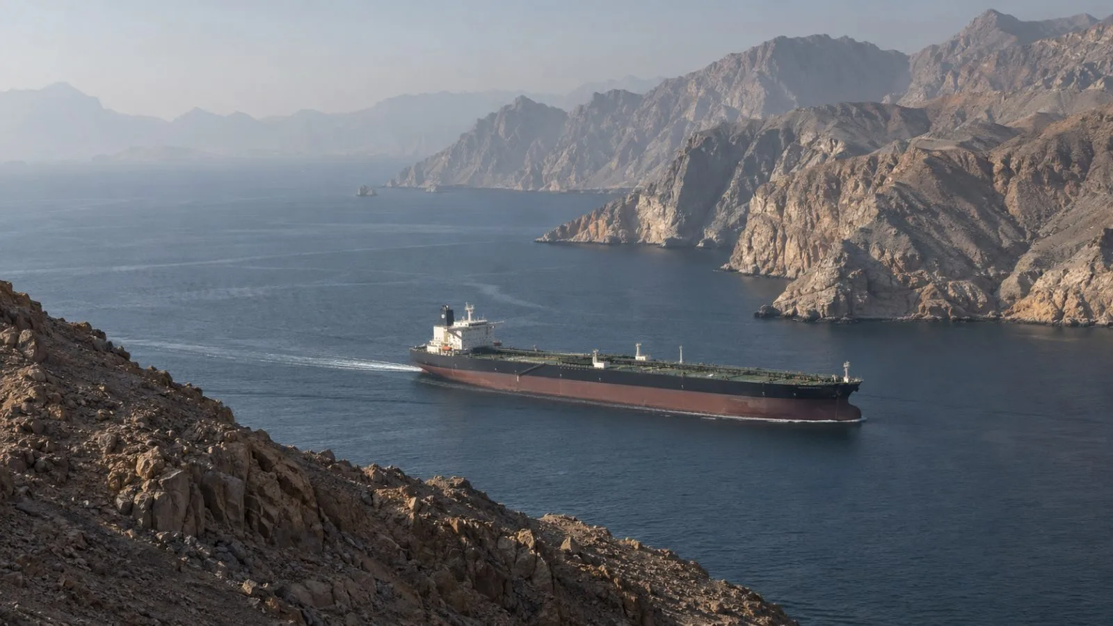 An oil tanker passes northeast of Limah, Oman, along the Strait of Hormuz. (AI-generated image / EconoTimes)