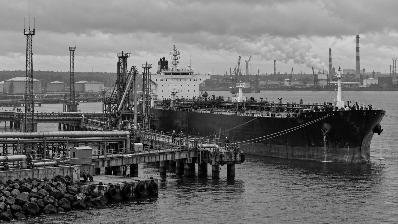A fuel tanker sits beside loading pipes at the Port of Ust-Luga near St. Petersburg (AI-generated image / EconoTimes)