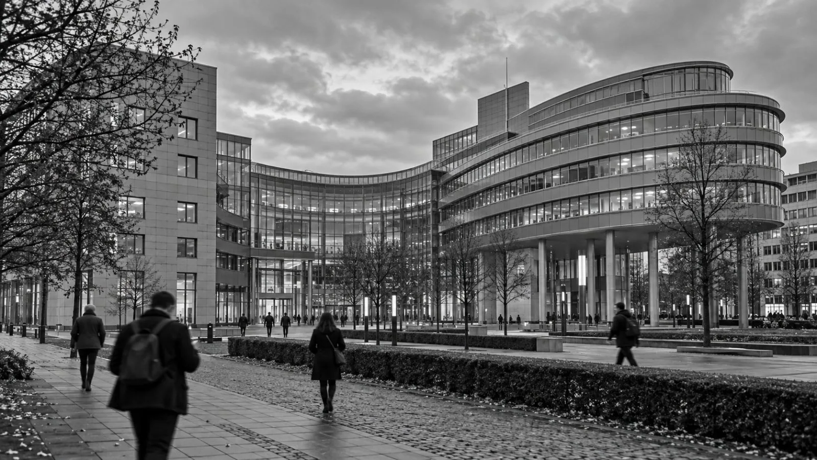 Pedestrians pass a telecommunications company headquarters in Bonn, Germany, under overcast skies. (AI-generated image / EconoTimes)