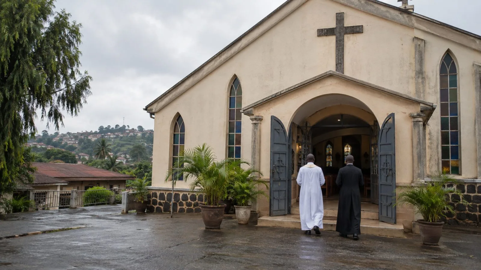 Clergy stand near a Catholic church entrance in Enugu, Nigeria, under an overcast morning sky. (AI-generated image / EconoTimes)