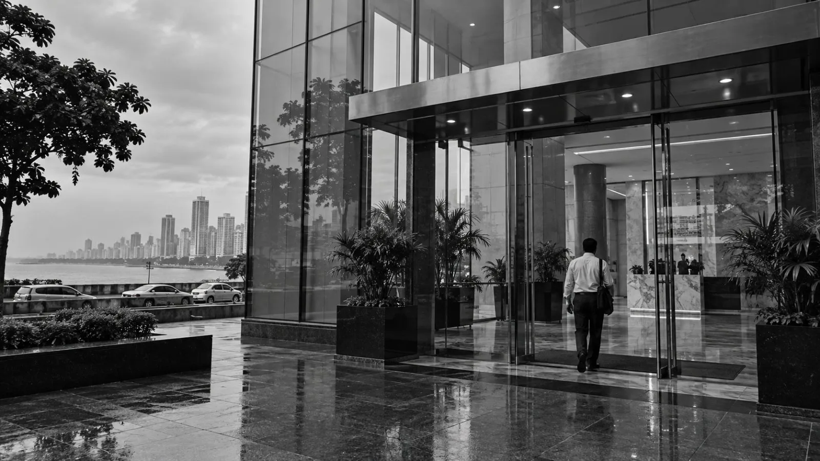 An employee enters a corporate office tower in Mumbai’s Nariman Point business district, India (AI-generated image / EconoTimes)