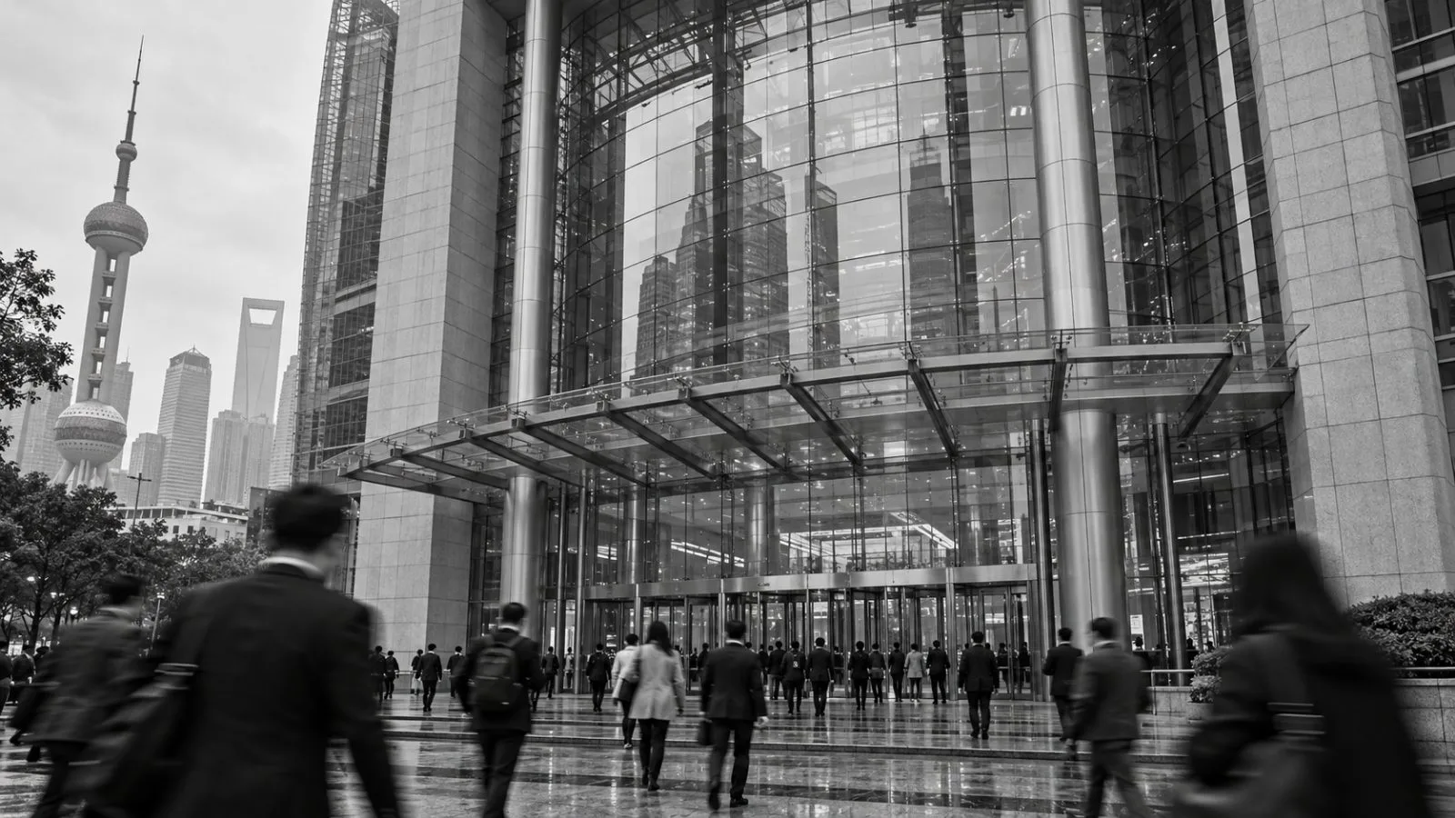 Commuters cross a rain-darkened plaza outside the Shanghai Stock Exchange in Pudong, Shanghai. / EconoTimes.ai (mono)