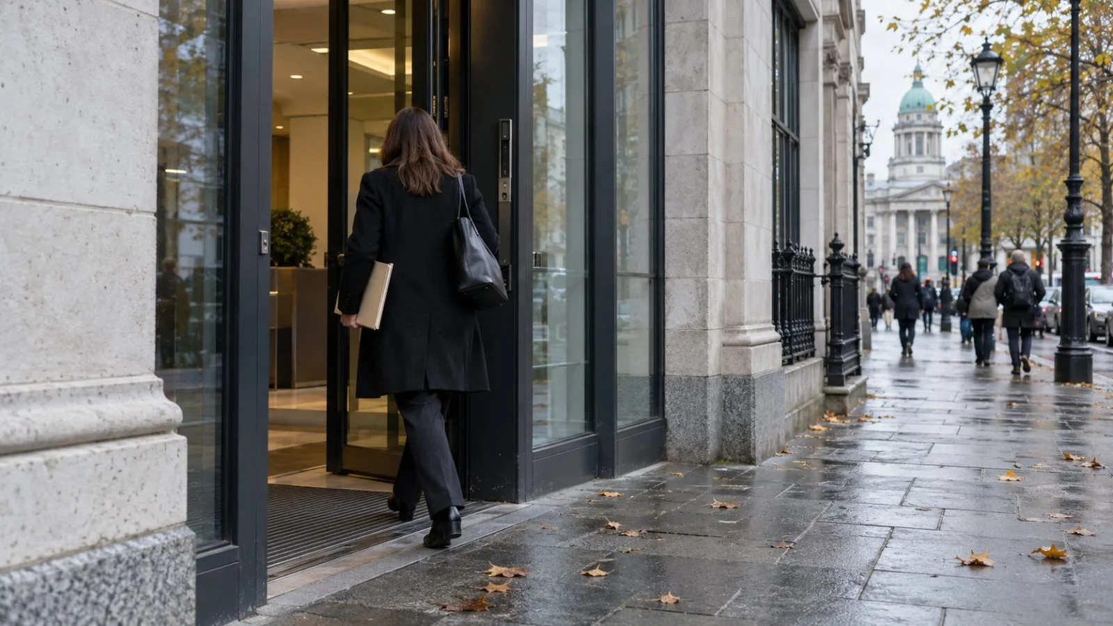 An employee carries a document folder into an office building in Dublin, Ireland, on an overcast morning. (AI-generated image / EconoTimes)