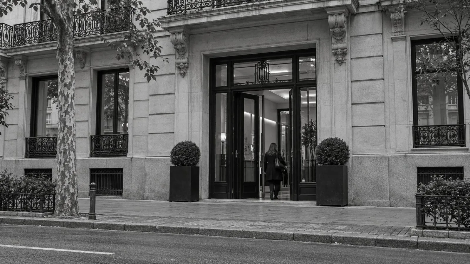 A person enters an office building on Calle Lagasca in Madrid, Spain. (AI-generated image / EconoTimes)