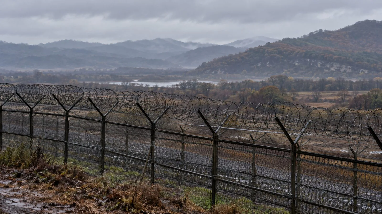 A security fence borders the Demilitarized Zone near Paju, South Korea, beneath overcast skies. (AI-generated image / EconoTimes)