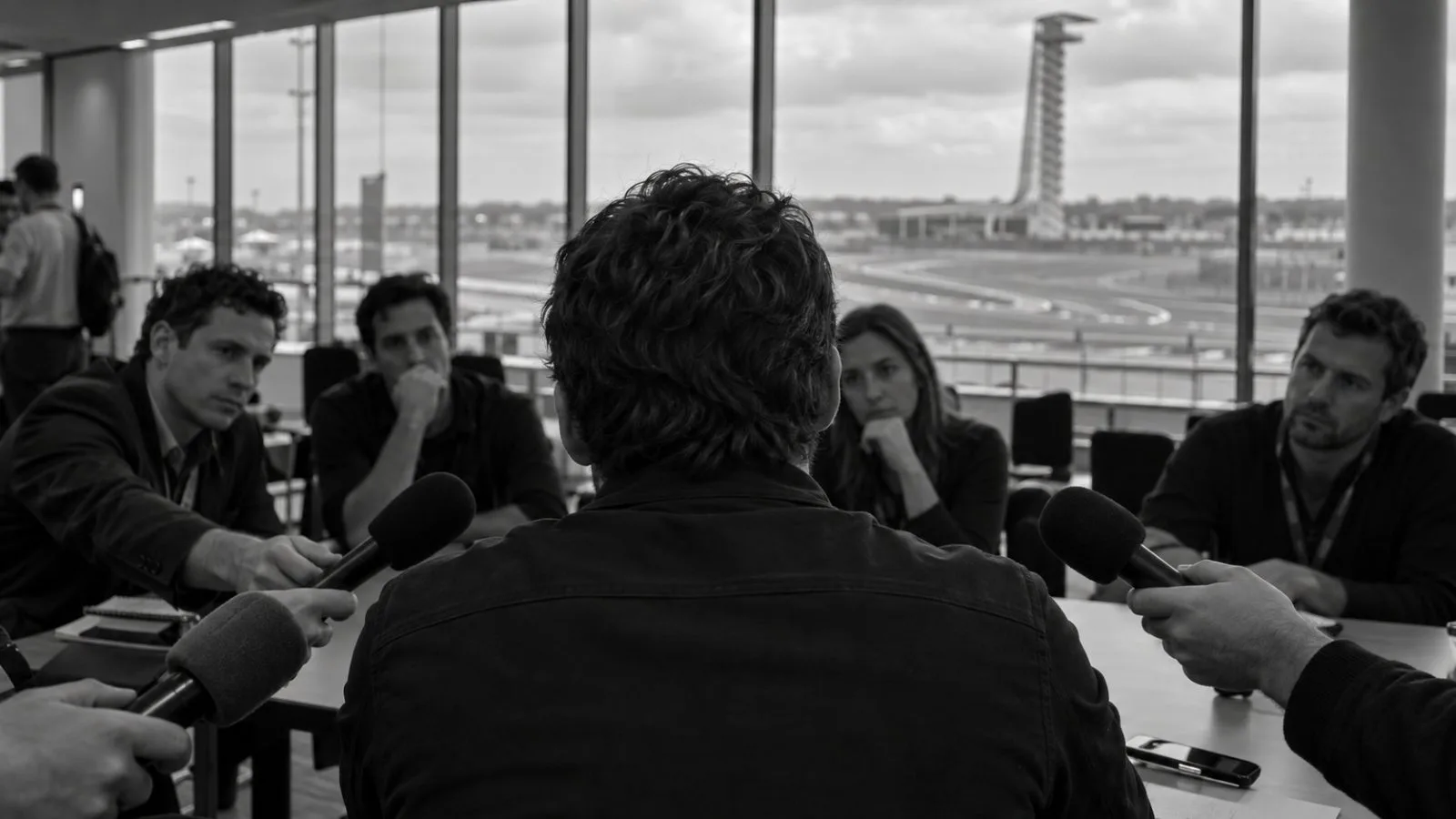 Microphones line a media table inside the Circuit of the Americas press room in Austin. (AI-generated image / EconoTimes)