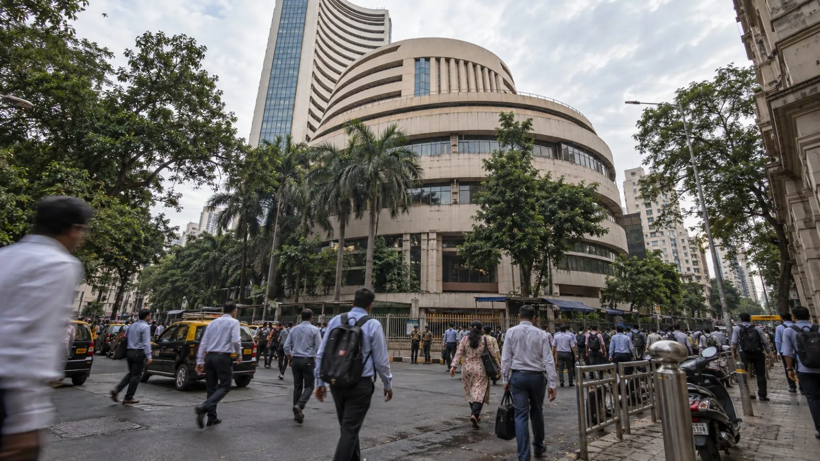 Commuters pass the Bombay Stock Exchange entrance on Dalal Street in Mumbai. (AI-generated image / EconoTimes)