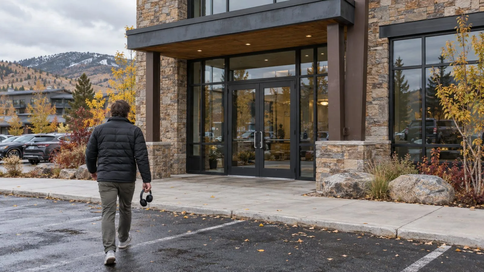 A passerby carries over-ear headphones outside an office at Redwood Shopping Center in Park City, Utah. (AI-generated image / EconoTimes)