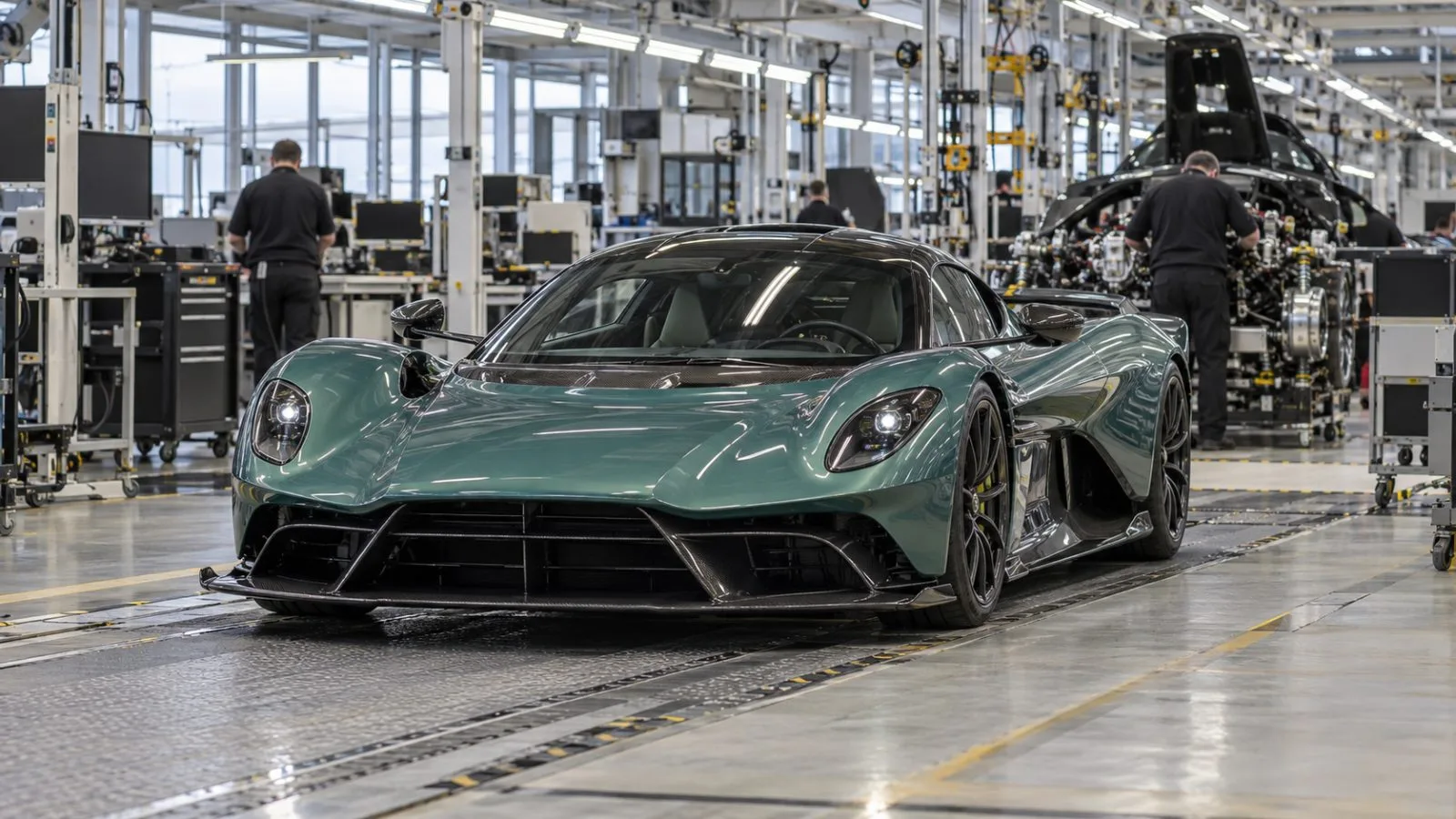 An Aston Martin Valhalla moves along the assembly line at the company’s Gaydon factory in England. (AI-generated image / EconoTimes)