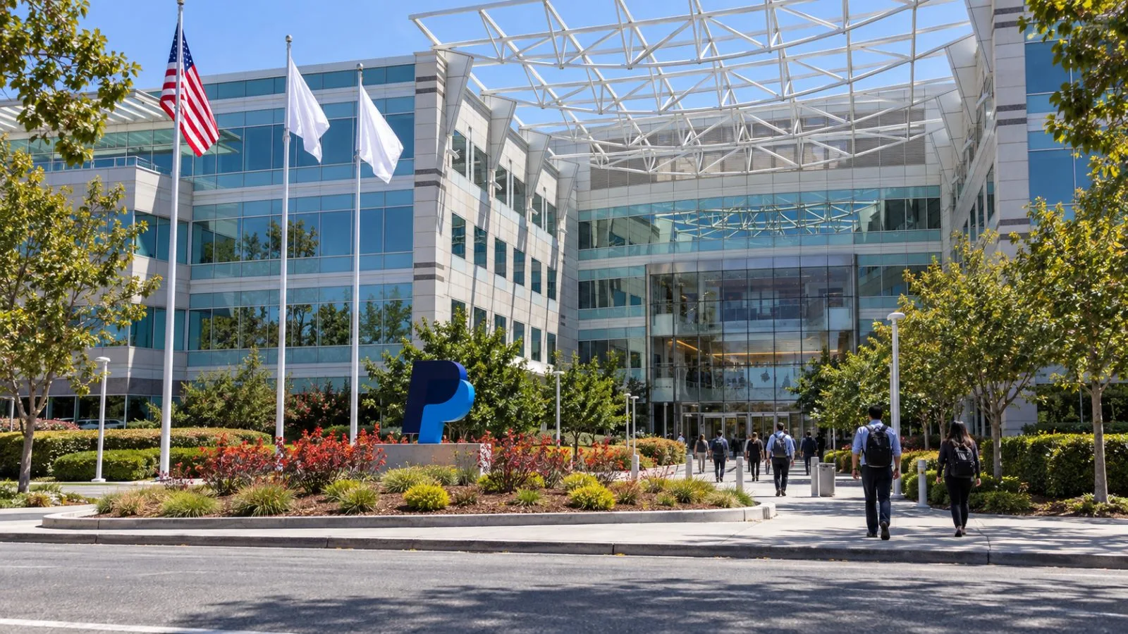 Office workers enter a glass corporate campus on North First Street in San Jose, California. / EconoTimes.ai