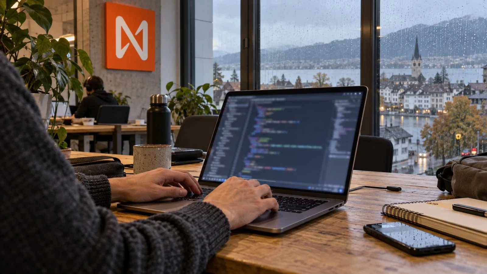 A developer reviews code on a laptop in a shared workspace in Zug, Switzerland. / EconoTimes.ai
