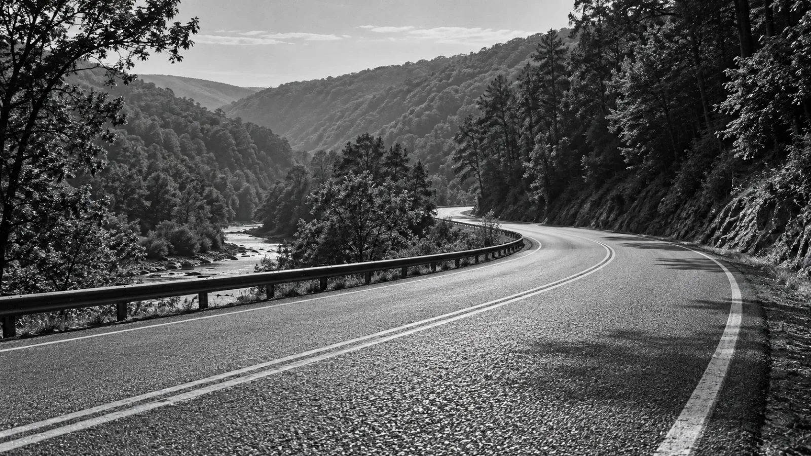 A treated highway curve winds through wooded hills in rural Pennsylvania. (AI-generated image / EconoTimes)