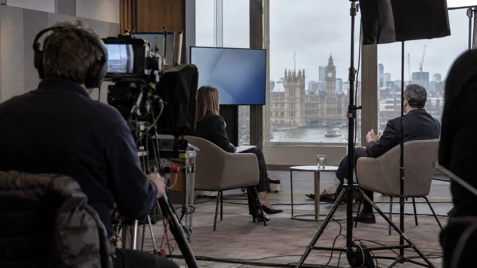 A camera operator films an interview inside a television studio in London. (AI-generated image / EconoTimes)