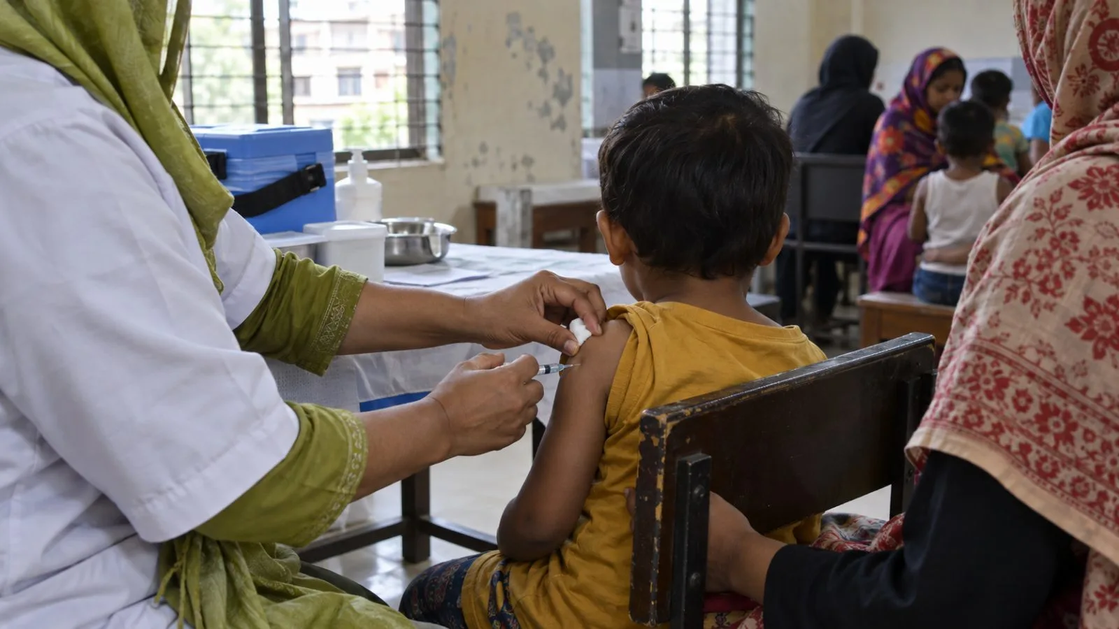 A health worker vaccinates a child at a clinic in Dhaka, Bangladesh. (AI-generated image / EconoTimes)