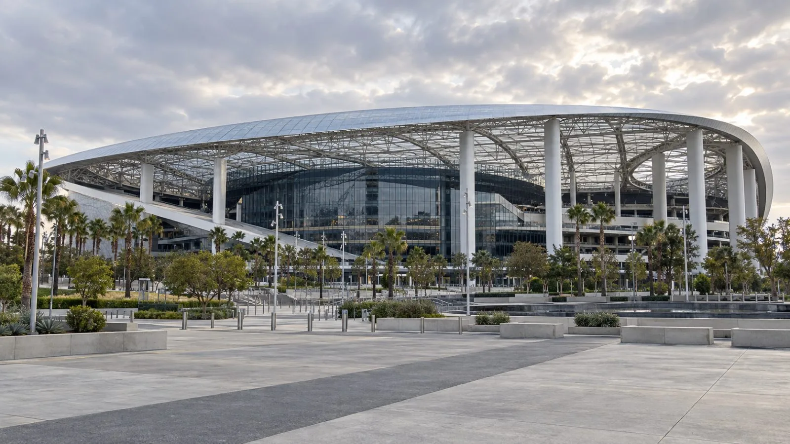 SoFi Stadium stands over an empty forecourt in Inglewood, California. / EconoTimes.ai