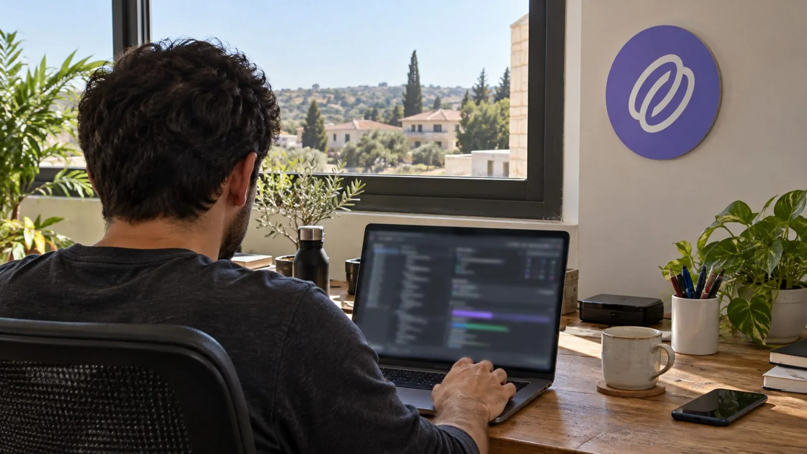 A developer checks coding agent activity at a laptop workstation in Tzur Yigal, Israel. / EconoTimes.ai