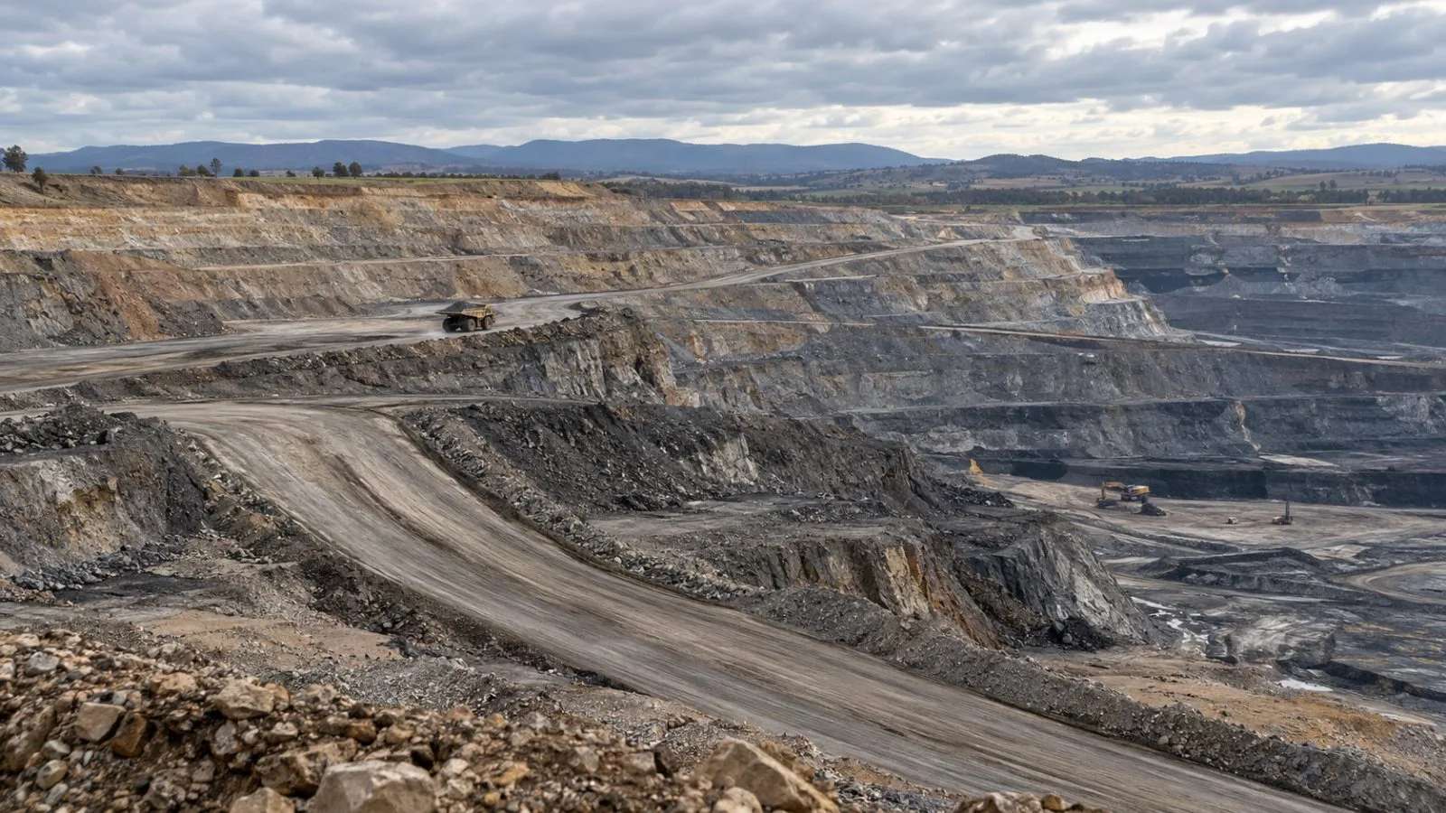 A haul truck moves along a bench at the Mount Pleasant coal mine near Muswellbrook, Australia. (AI-generated image / EconoTimes)