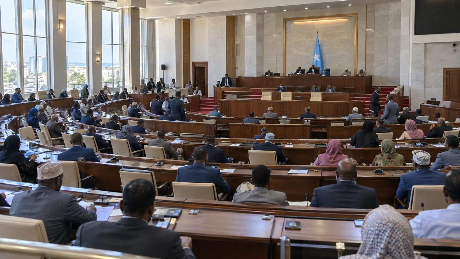 Somali lawmakers sit in the lower house chamber of the Federal Parliament in Mogadishu. (AI-generated image / EconoTimes)