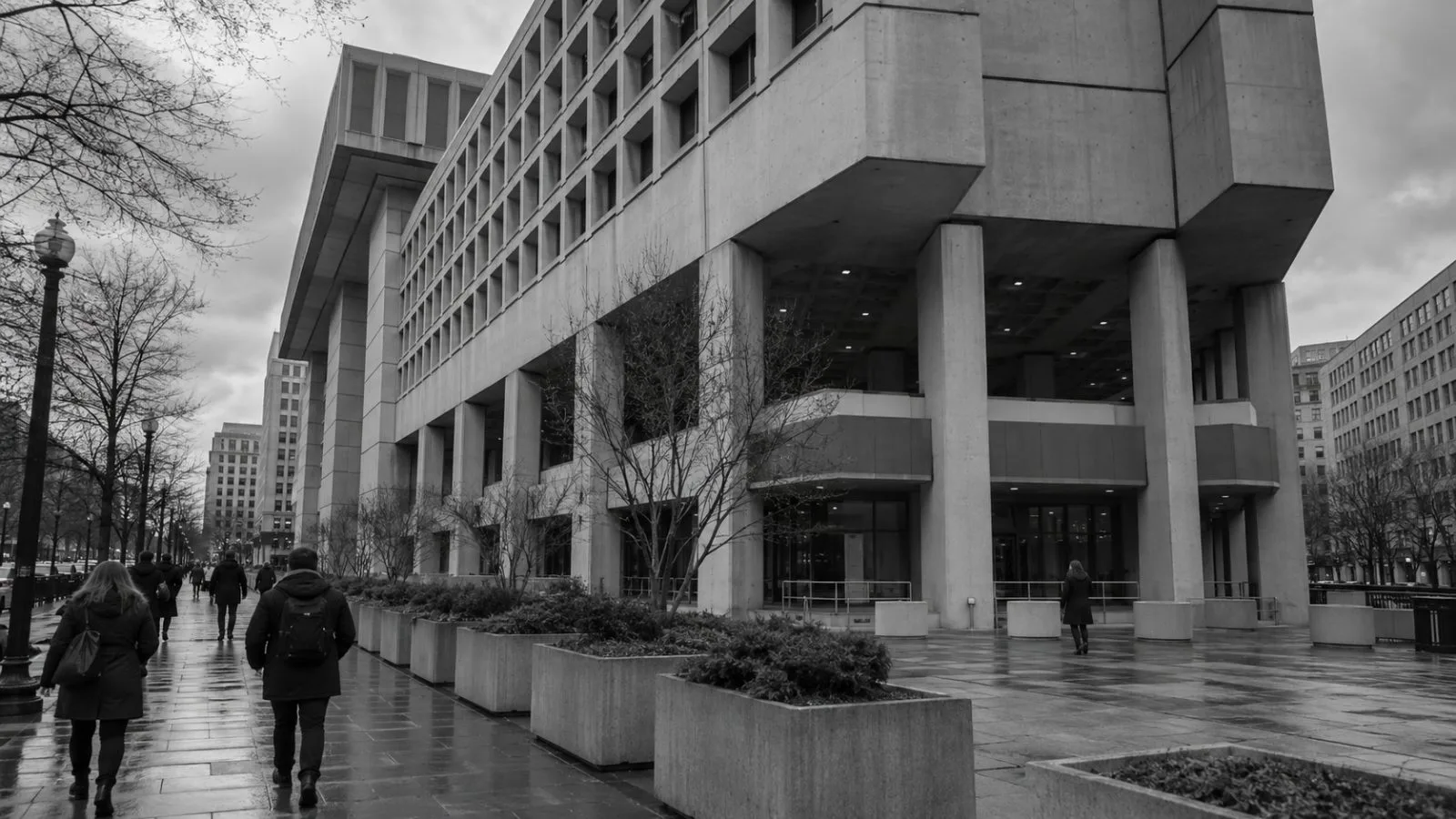 Pedestrians pass the FBI headquarters along Pennsylvania Avenue in Washington, D.C., beneath an overcast sky. (AI-generated image / EconoTimes)