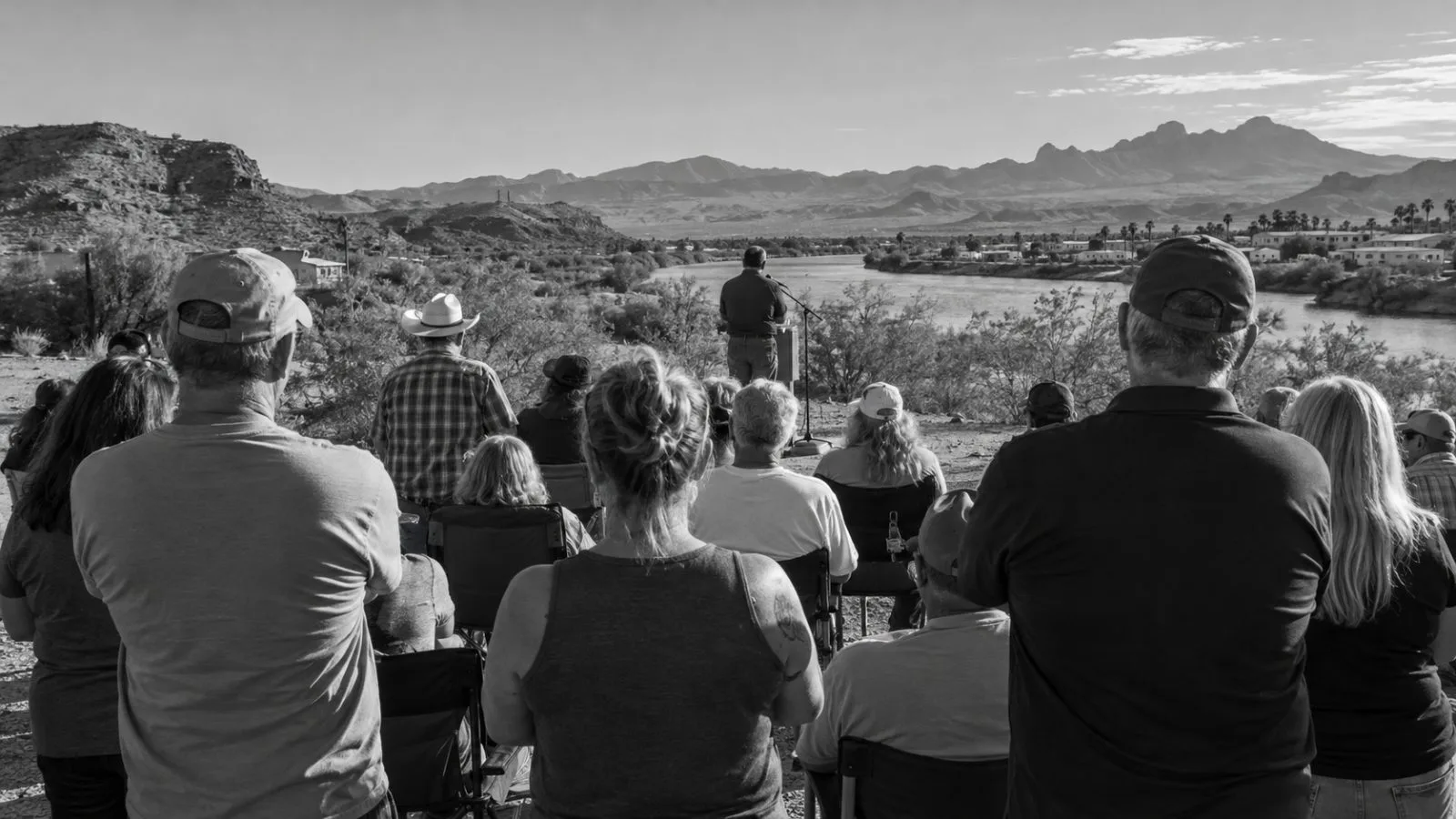 Attendees gather at a campaign rally in Bullhead City, Arizona, in daylight. (AI-generated image / EconoTimes)