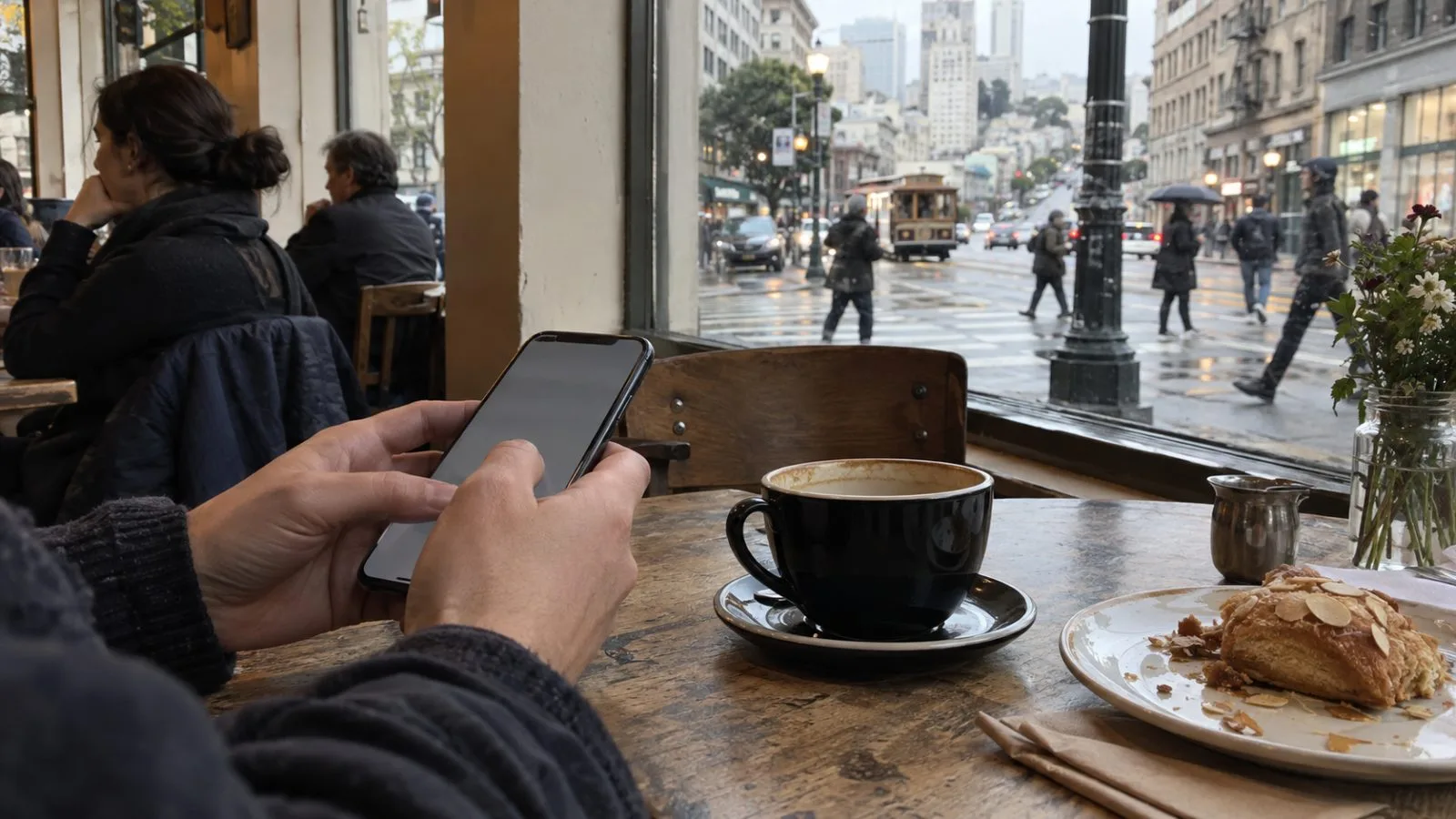 A customer checks a smartphone inside a cafe near Union Square in San Francisco, California. (AI-generated image / EconoTimes)