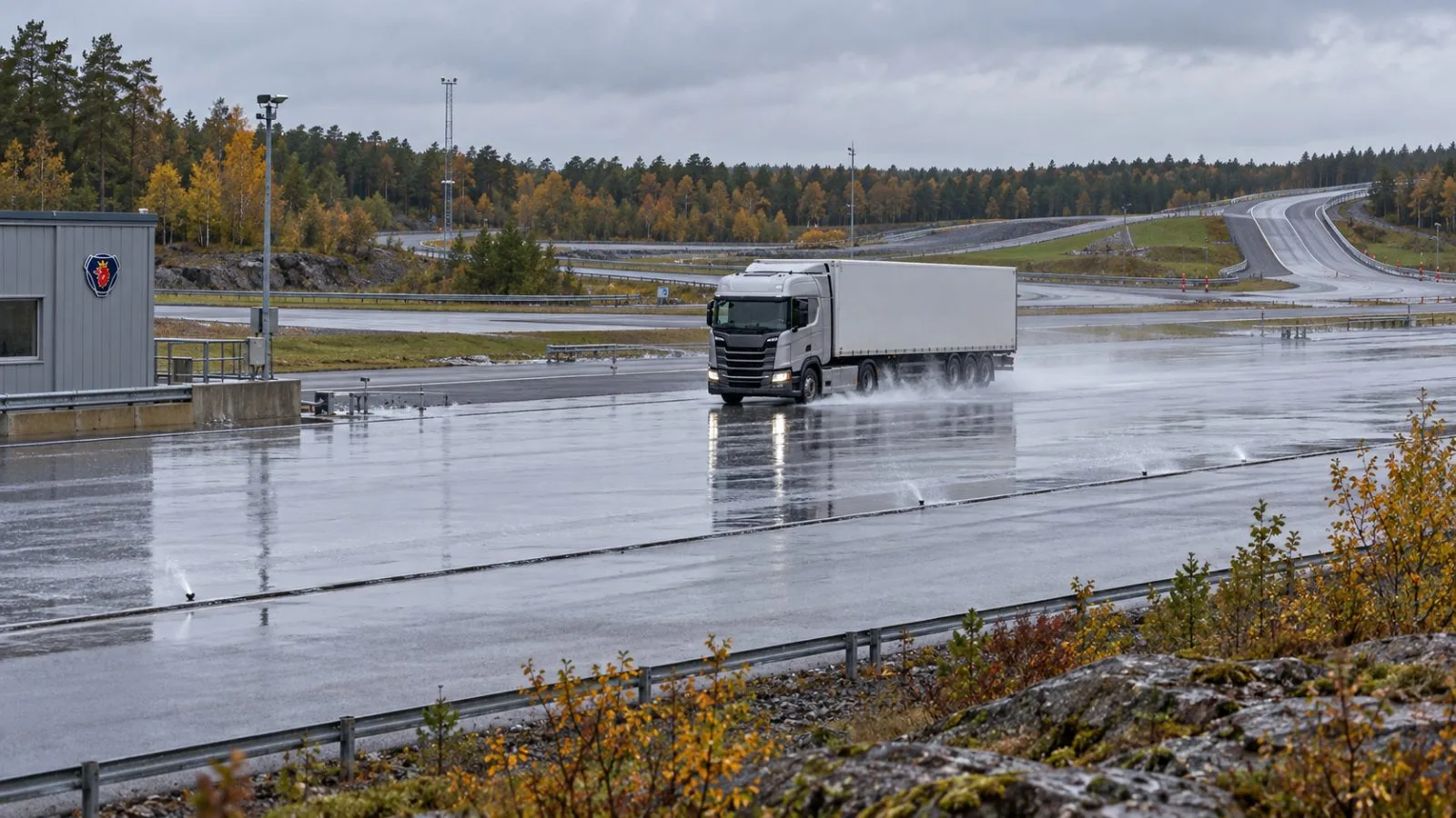 A heavy truck follows a wet braking track at Scania’s proving ground in Södertälje, Sweden / EconoTimes.ai