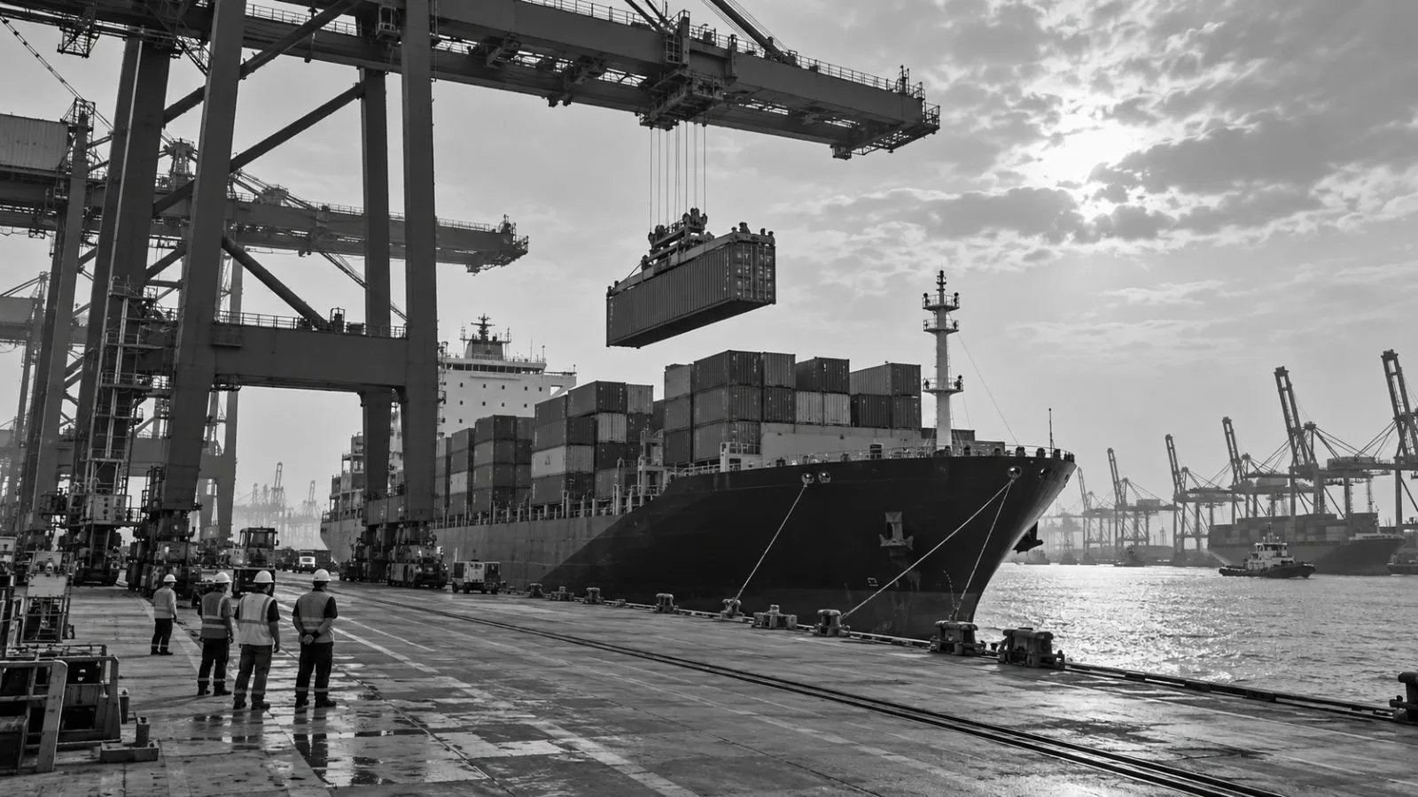 A crane loads containers onto a cargo vessel at Jawaharlal Nehru Port in India. (AI-generated image / EconoTimes)