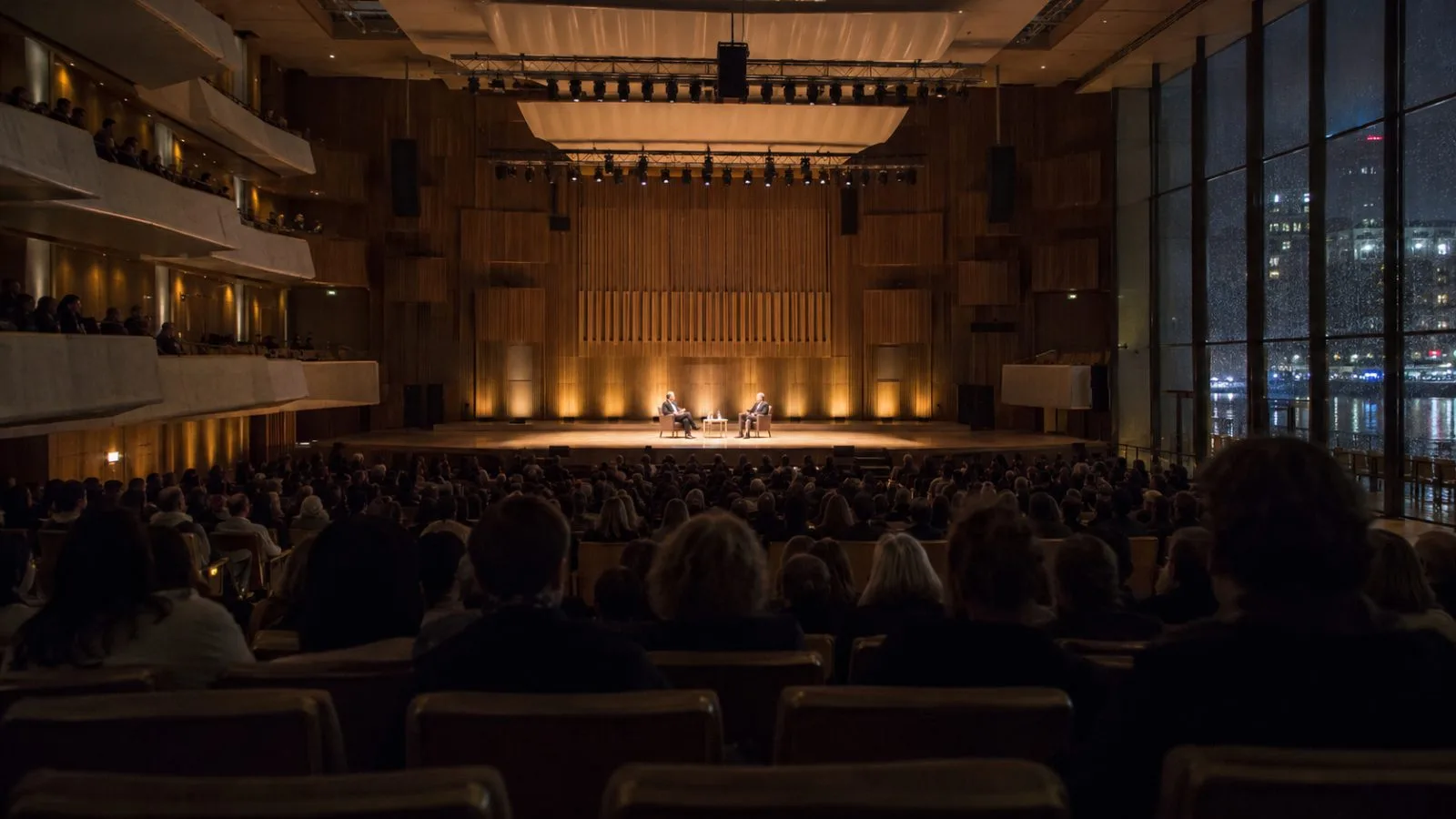 Audience members listen during a literary discussion at the Royal Festival Hall in London (AI-generated image / EconoTimes)