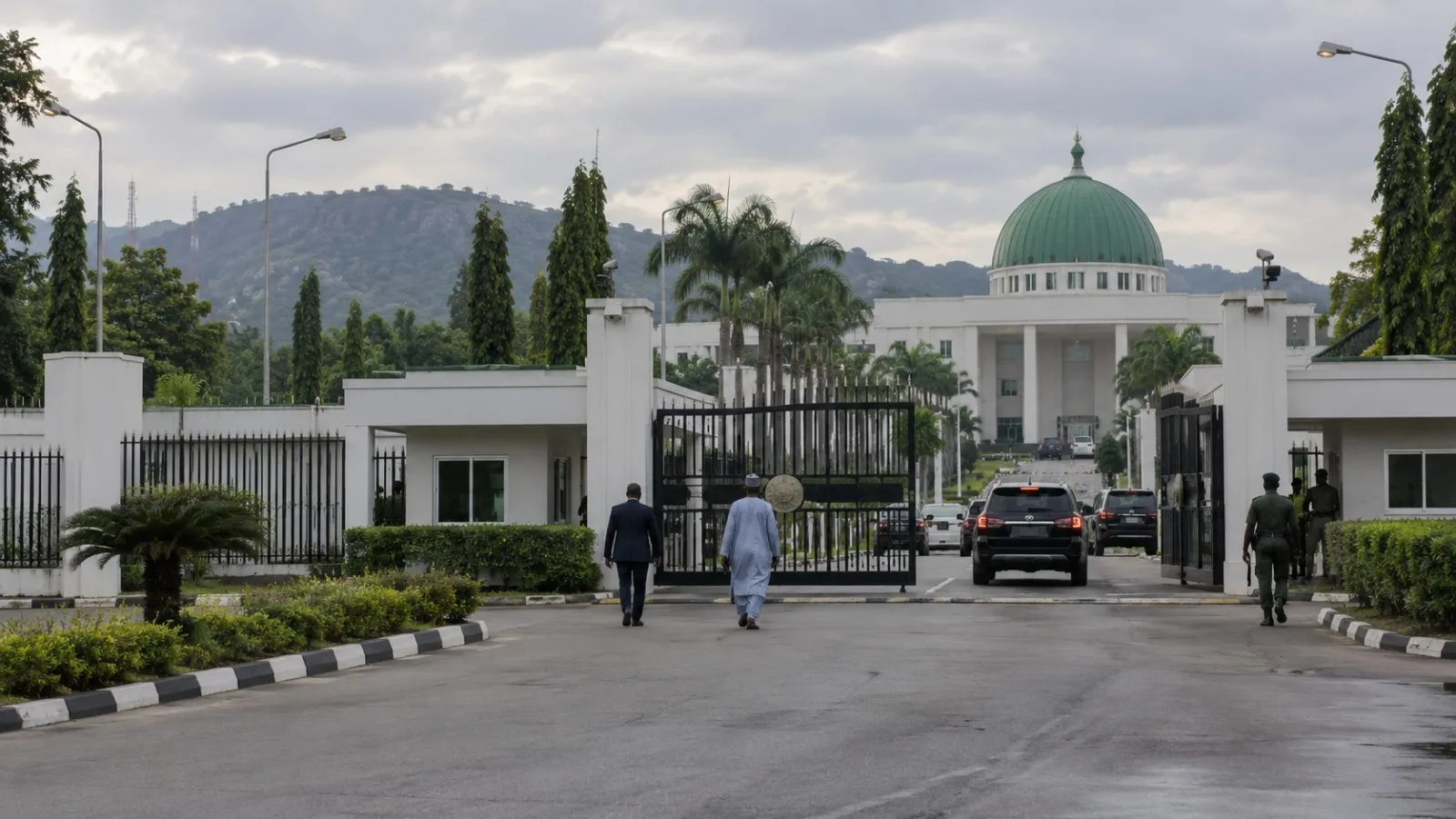 Staff walk through the State House entrance in Abuja under an overcast sky. (AI-generated image / EconoTimes)