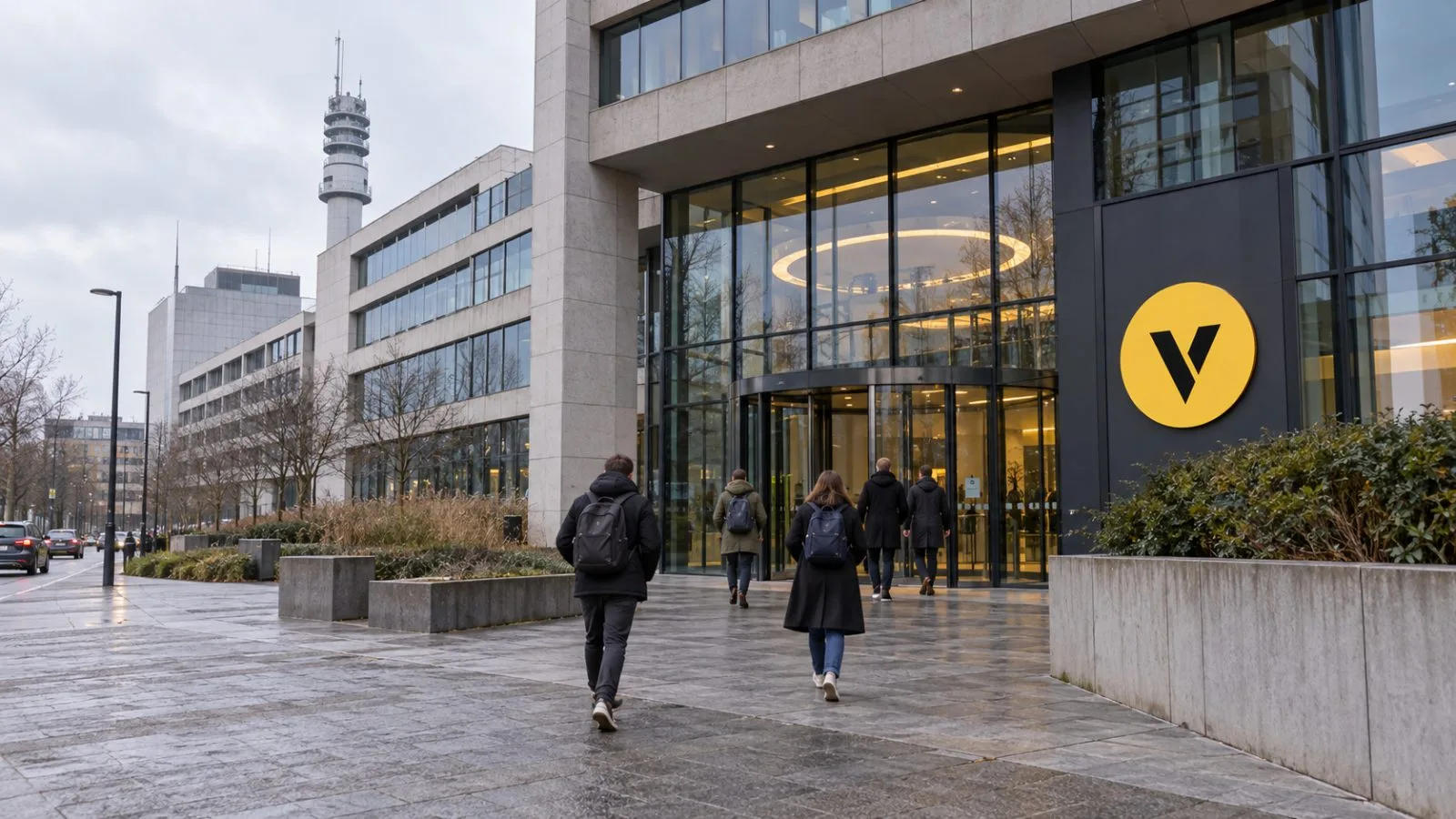 Employees enter VRT headquarters on Reyerslaan in Brussels, Belgium, on an overcast morning. / EconoTimes.ai