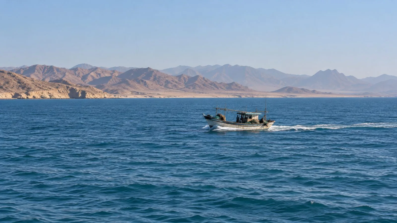 A small fishing boat moves across the Red Sea off Tabuk, Saudi Arabia. / EconoTimes.ai