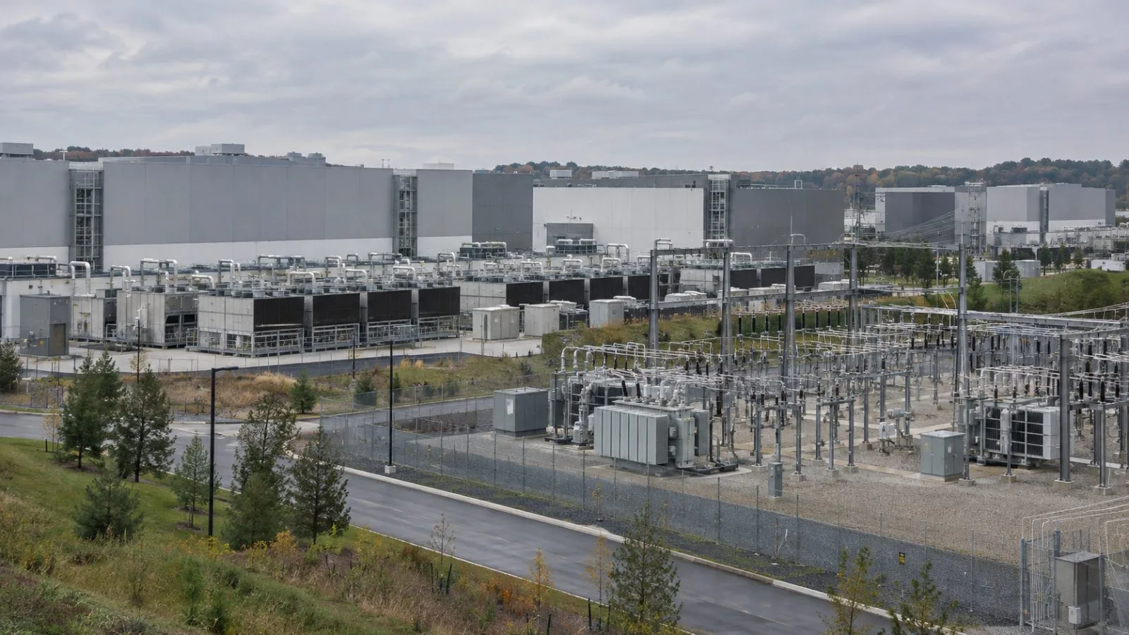 Cooling equipment and a power substation stand beside a data center campus in Ashburn, Virginia. (AI-generated image / EconoTimes)
