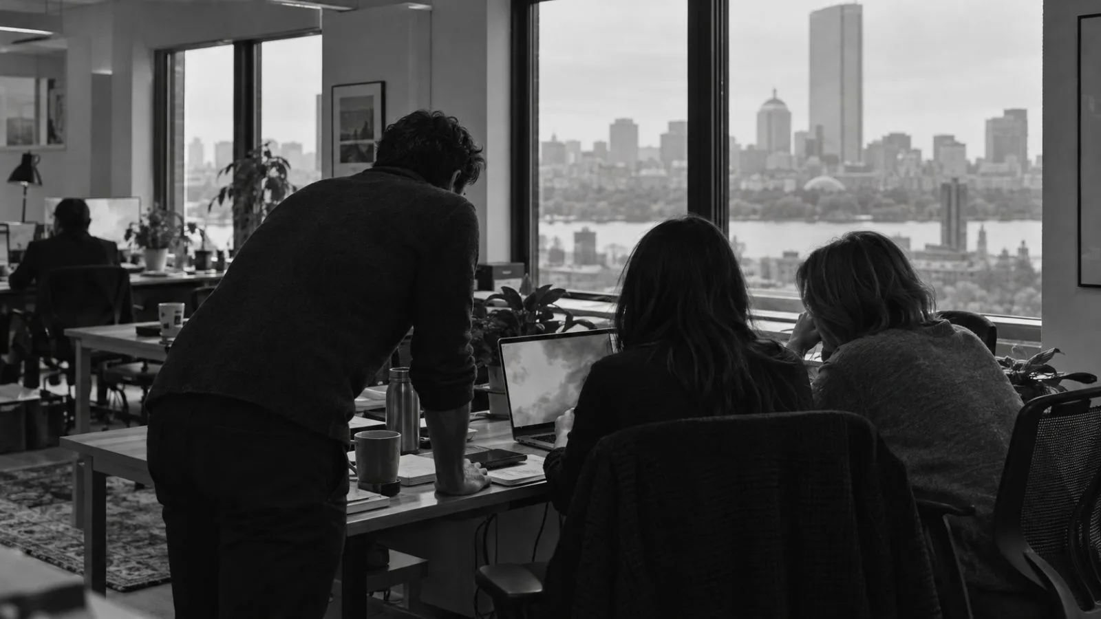 Employees review a vendor security assessment at SpartanX's Boston headquarters. (AI-generated image / EconoTimes)