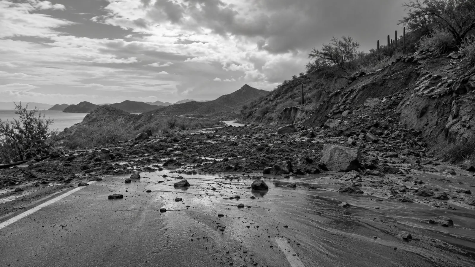 Mud and rocks block a rural road east of Guaymas, Sonora, after Hurricane Polo. (AI-generated image / EconoTimes)
